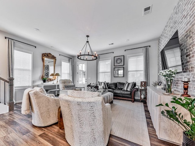 living room featuring hardwood / wood-style floors and a notable chandelier