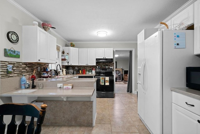 kitchen featuring kitchen peninsula, black appliances, white cabinets, and ornamental molding