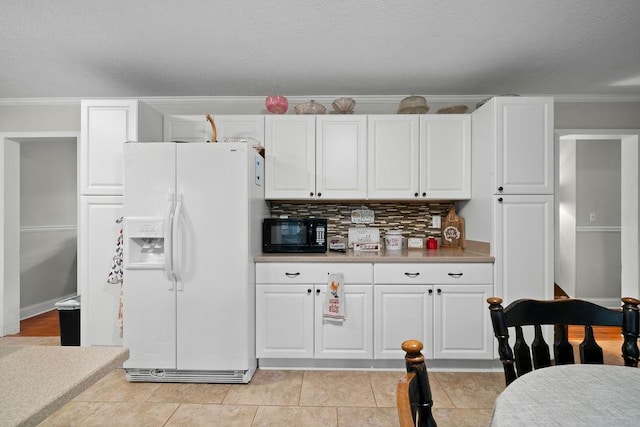 kitchen with white cabinetry, white fridge with ice dispenser, and tasteful backsplash