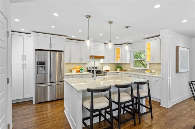 kitchen featuring glass insert cabinets, appliances with stainless steel finishes, white cabinets, and dark wood-style flooring