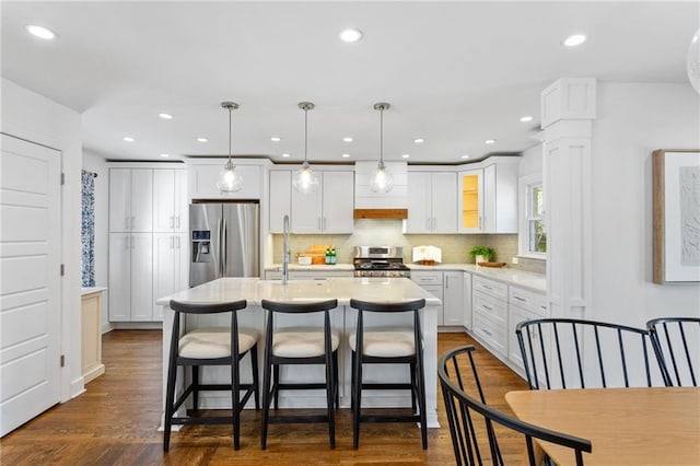 kitchen with white cabinetry, light countertops, backsplash, and appliances with stainless steel finishes