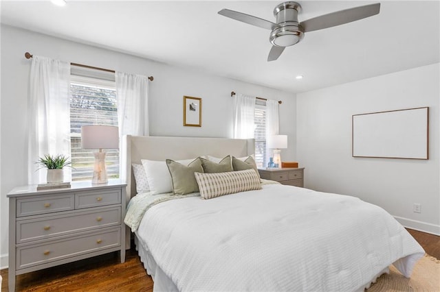 bedroom featuring dark wood-style floors, recessed lighting, multiple windows, and baseboards