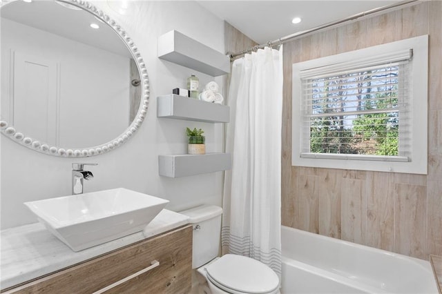 bathroom featuring vanity, shower / bath combination with curtain, toilet, and recessed lighting