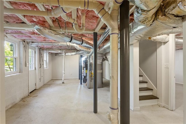 basement featuring gas water heater and stairs