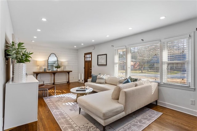 living area featuring recessed lighting, wood finished floors, and baseboards