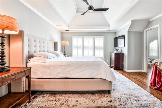 bedroom featuring multiple windows, wood finished floors, baseboards, and ornamental molding