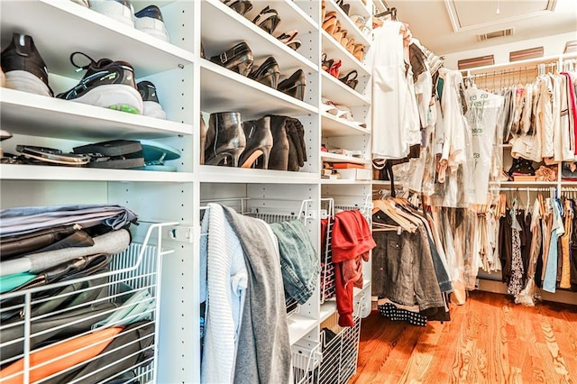 walk in closet with wood finished floors and visible vents