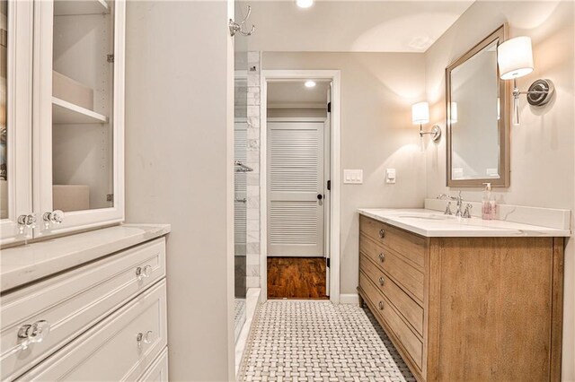 full bathroom with two vanities and a sink