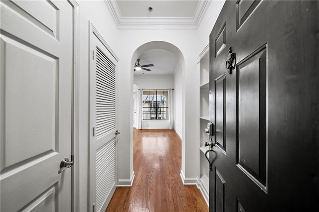 corridor featuring ornamental molding and dark hardwood / wood-style floors