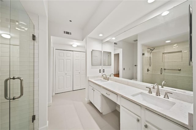 bathroom featuring vanity, tile patterned flooring, a shower with shower door, and toilet