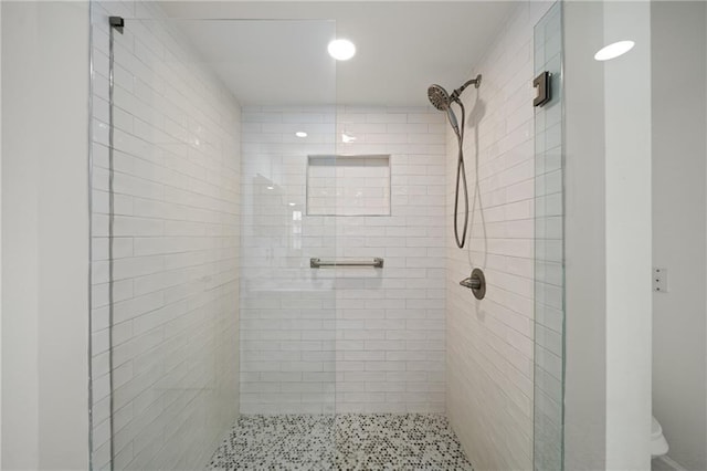 bathroom with a tile shower