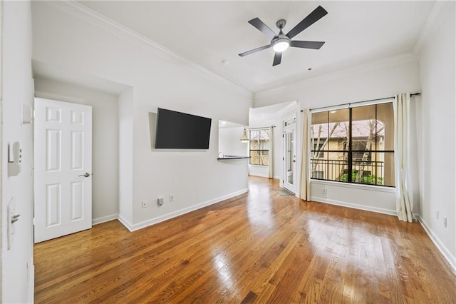 unfurnished living room featuring hardwood / wood-style flooring, ornamental molding, and ceiling fan