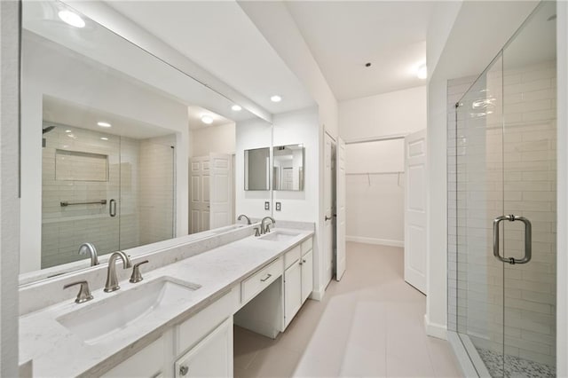 bathroom featuring vanity, tile patterned floors, and a shower with shower door