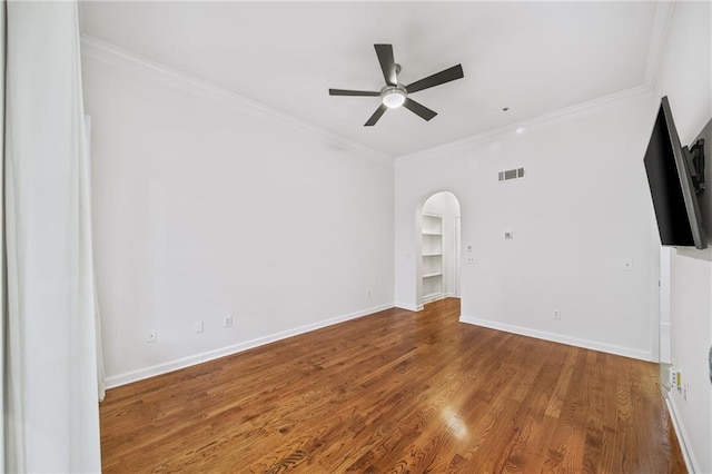 spare room featuring ceiling fan, ornamental molding, and wood-type flooring