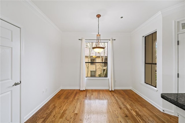 unfurnished dining area with wood-type flooring and ornamental molding