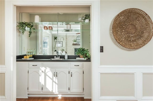 bar with sink and white cabinets