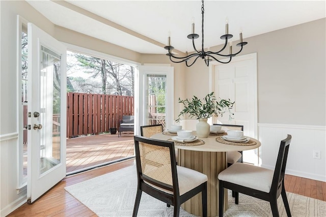 dining area with a chandelier and light hardwood / wood-style flooring