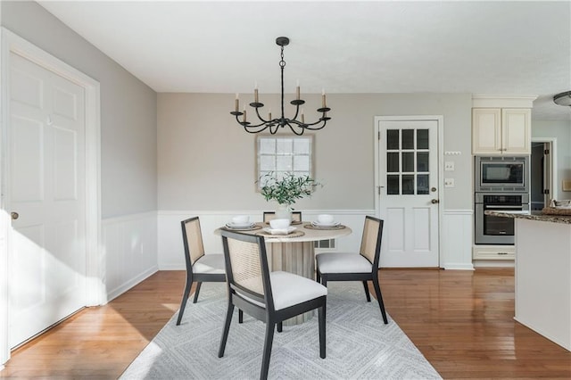 dining space featuring a chandelier and light hardwood / wood-style flooring