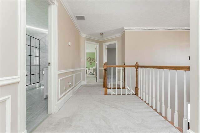 hallway with light colored carpet and ornamental molding