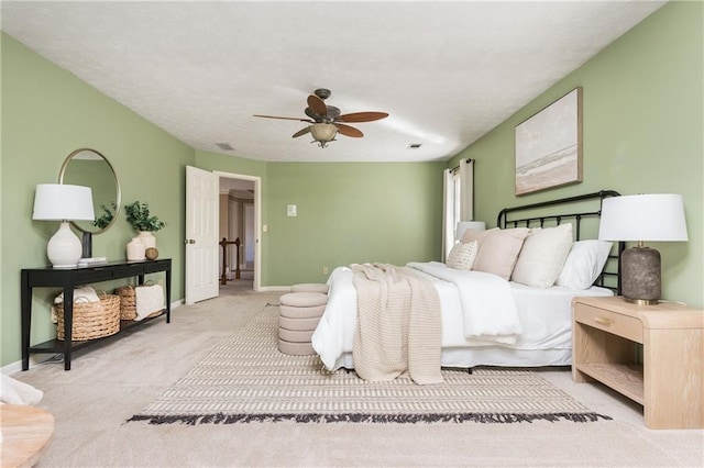 bedroom featuring light carpet and ceiling fan