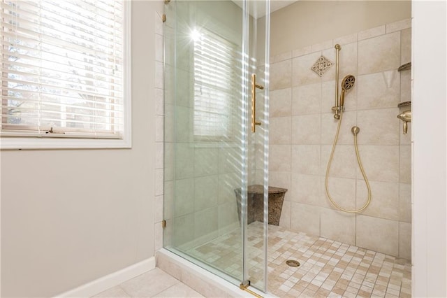 bathroom with tile patterned floors and a shower with door