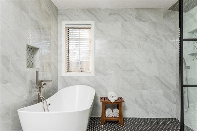 bathroom featuring tile walls and shower with separate bathtub