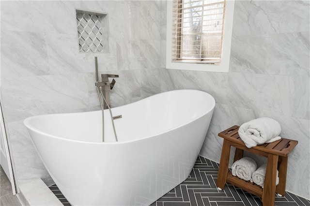 bathroom featuring tile walls and a tub