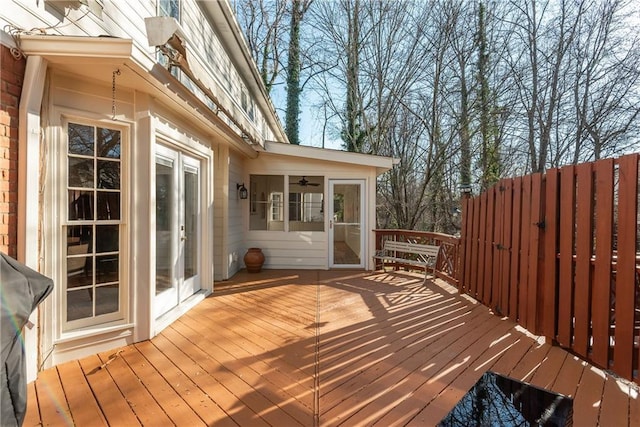 wooden terrace featuring ceiling fan and area for grilling