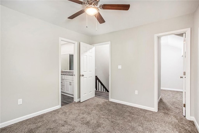 unfurnished bedroom with ensuite bathroom, carpet floors, and ceiling fan