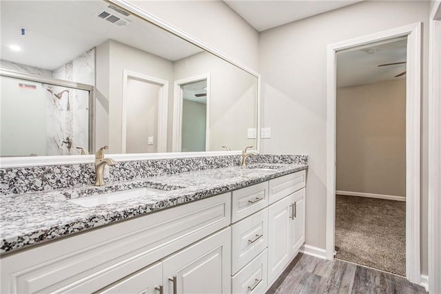 bathroom featuring vanity, a shower with shower door, and hardwood / wood-style flooring