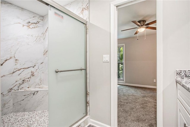 bathroom with vanity, ceiling fan, and walk in shower