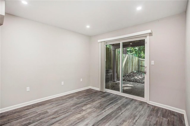 empty room with hardwood / wood-style flooring