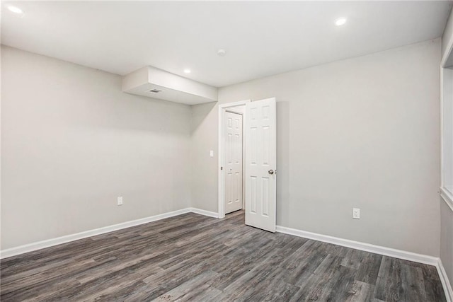 spare room with dark wood-type flooring