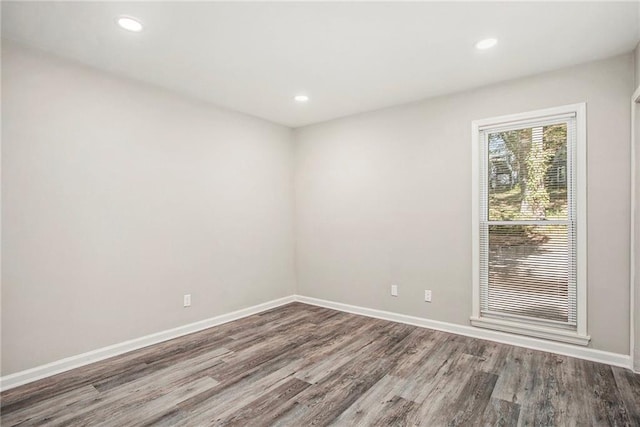 unfurnished room with hardwood / wood-style floors