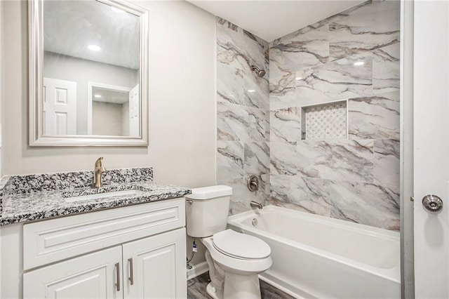 full bathroom featuring vanity, toilet, hardwood / wood-style flooring, and tiled shower / bath combo