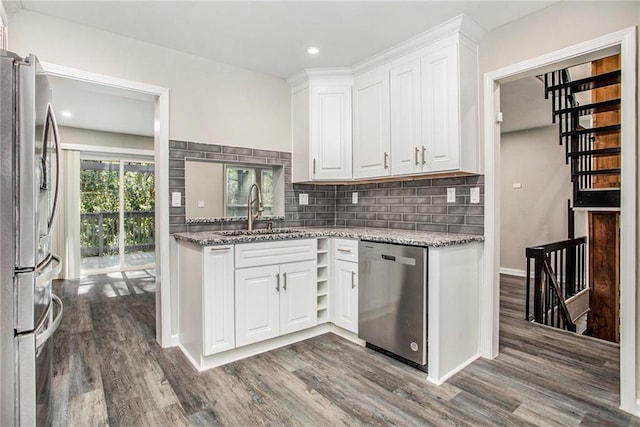 kitchen featuring hardwood / wood-style floors, sink, white cabinets, and stainless steel appliances