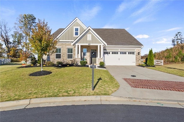 craftsman-style home featuring a front yard and a garage