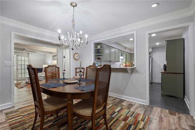 dining area with a notable chandelier, wood-type flooring, and ornamental molding