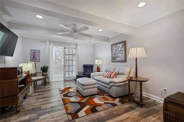 living room with french doors, ornamental molding, ceiling fan, dark wood-type flooring, and beam ceiling