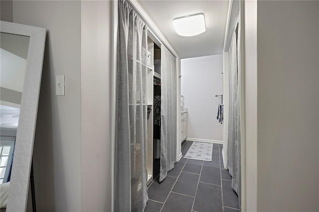 corridor with dark tile patterned floors