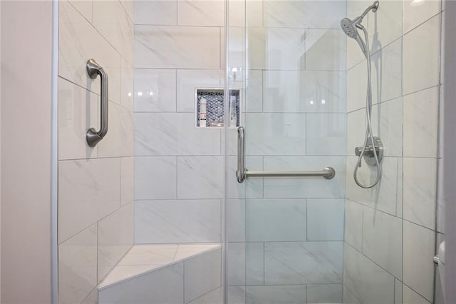 bathroom with a shower with door