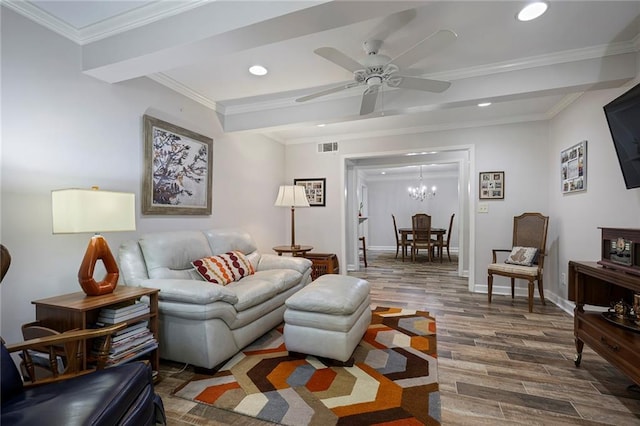 living room featuring dark hardwood / wood-style floors, ornamental molding, and ceiling fan with notable chandelier