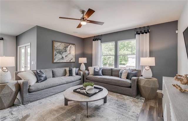 living room featuring hardwood / wood-style flooring and ceiling fan