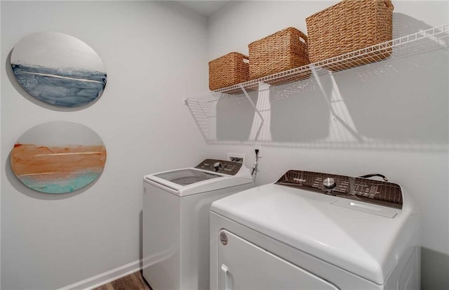 laundry area featuring hardwood / wood-style floors and washing machine and clothes dryer