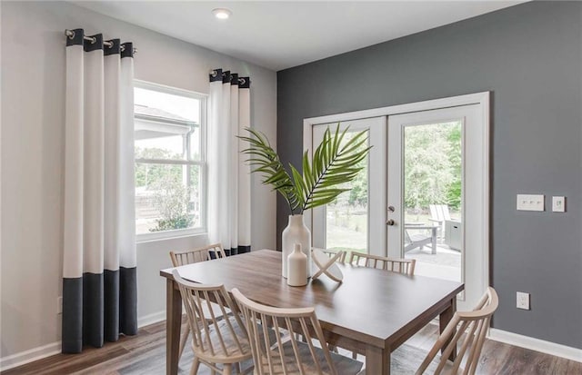 dining area featuring dark wood-type flooring, a healthy amount of sunlight, and french doors