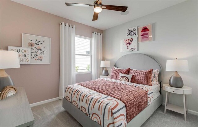 bedroom with ceiling fan and light carpet