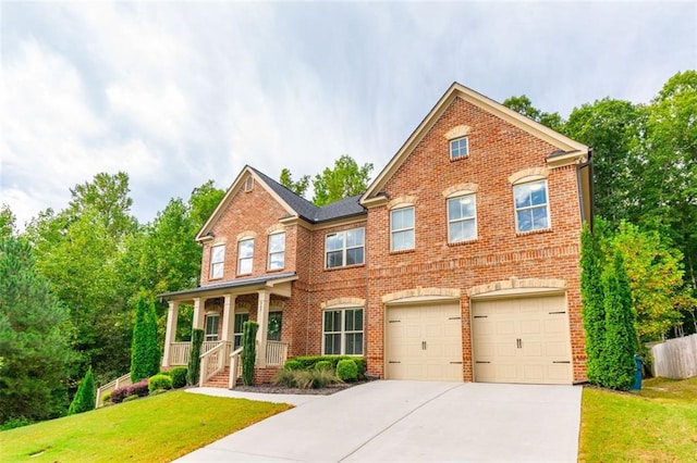 craftsman-style home featuring a garage, covered porch, and a front lawn