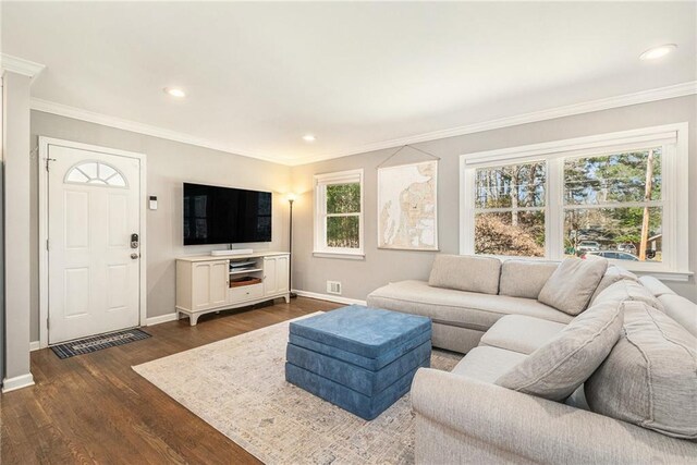 living room featuring ornamental molding, dark wood-type flooring, recessed lighting, and baseboards