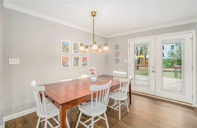 dining space with crown molding, baseboards, wood finished floors, and french doors