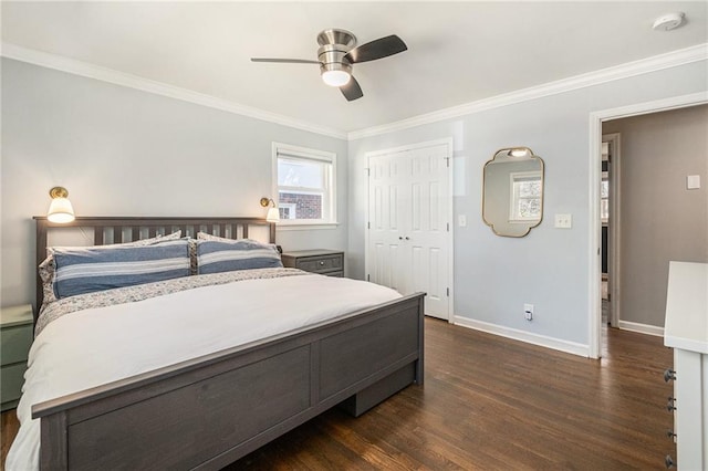 bedroom with dark wood-type flooring, a ceiling fan, baseboards, a closet, and crown molding